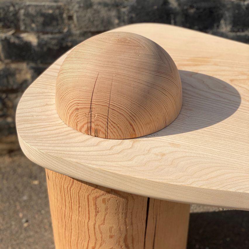 A wooden table with a globe detail