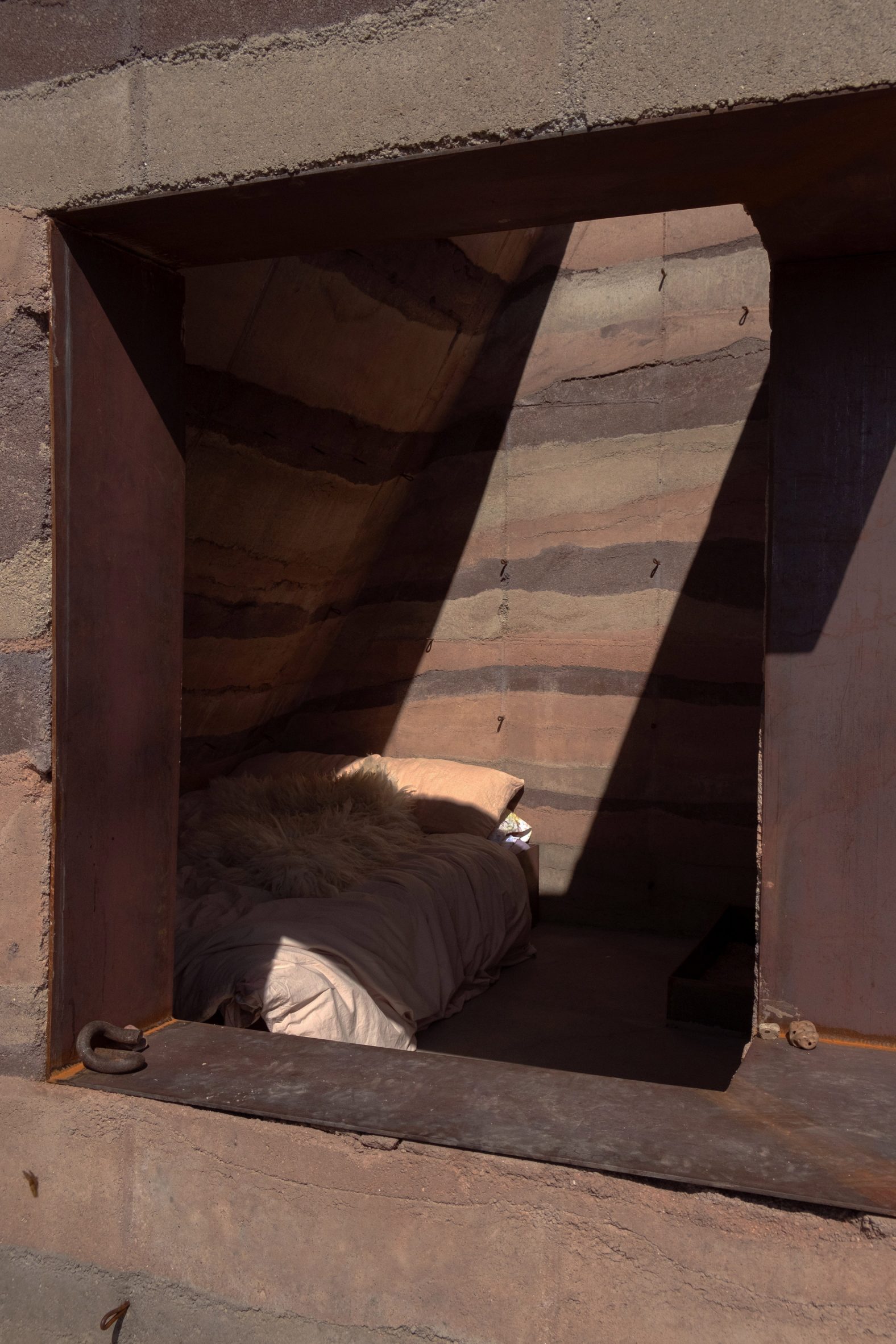 rammed earth shelter through the window