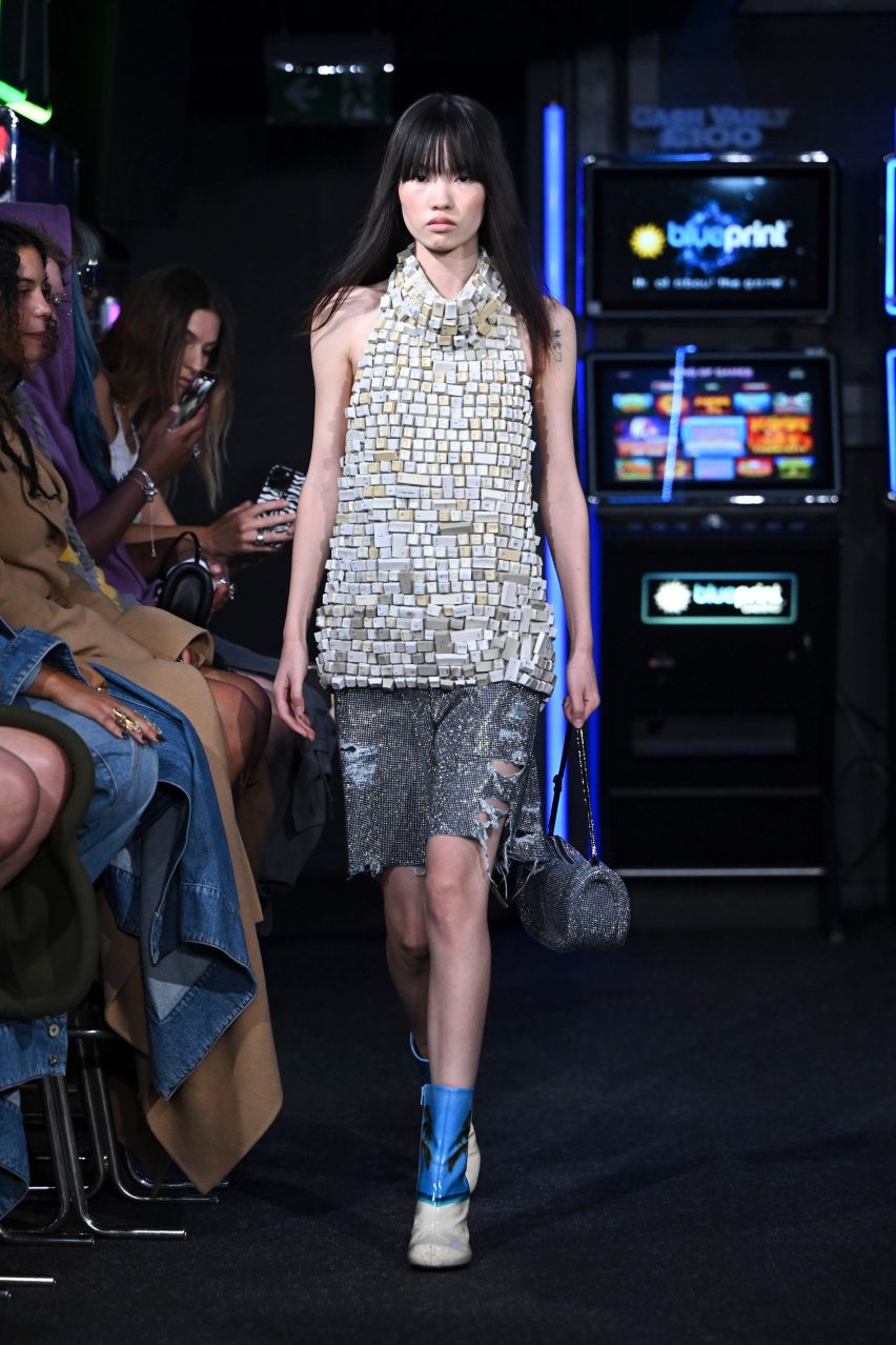 A top made from computer keys walks between arcade machines at JW Anderson Spring Summer 2023