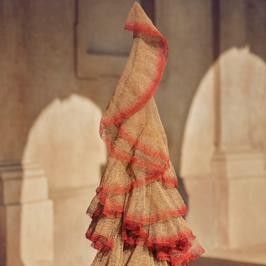 A beige and red fabric hangs