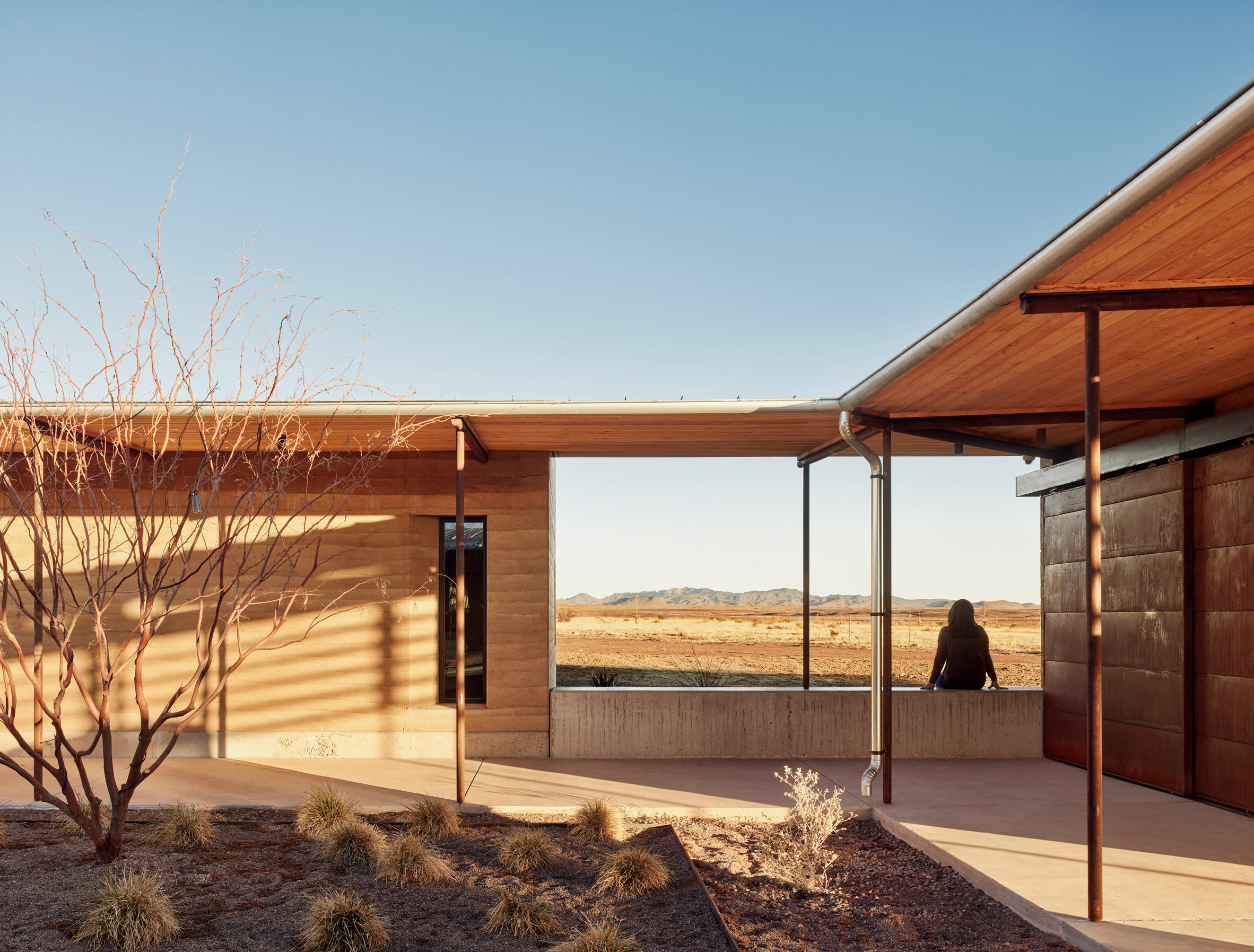 Rammed earth walls of house with covered walkway and central courtyard