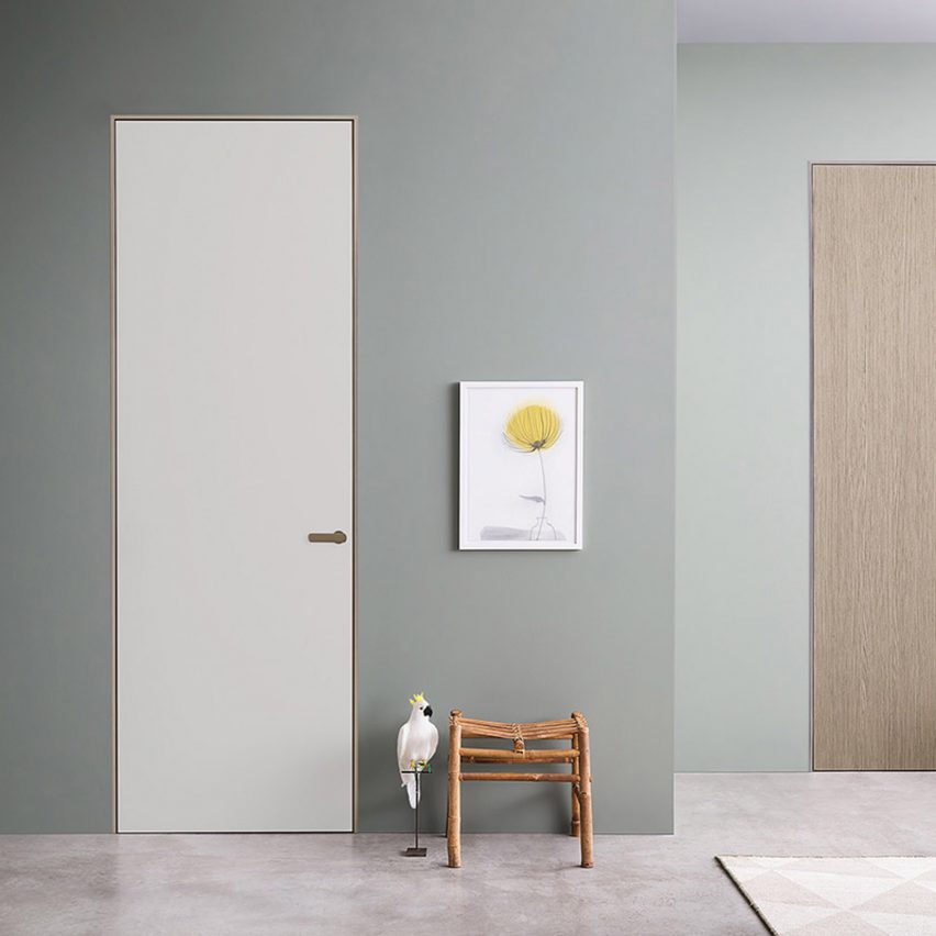 Two Lualdi doors in a teal painted hallway, one door is white and the other is finished in oak