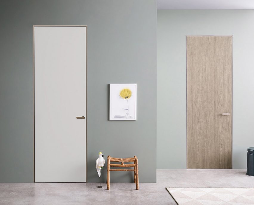 Two Lualdi doors in a teal-painted hallway, one door is white and the other is finished in oak