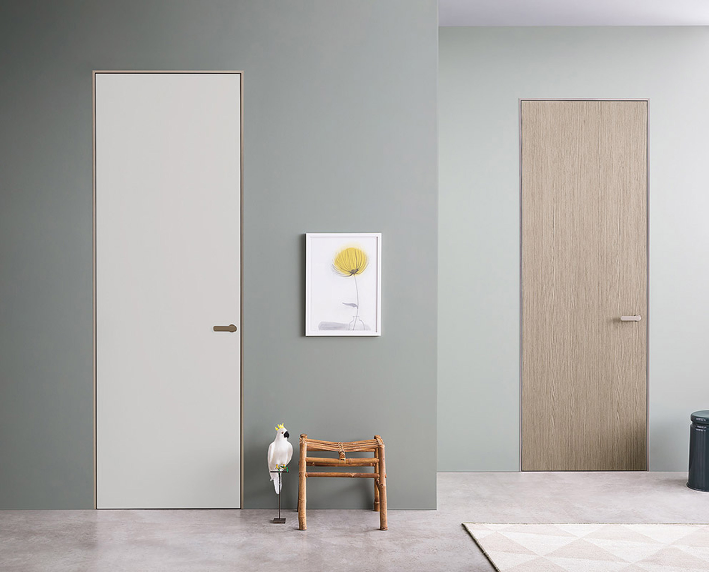 Two Lualdi doors in a teal-painted hallway, one door is white and the other is finished in oak