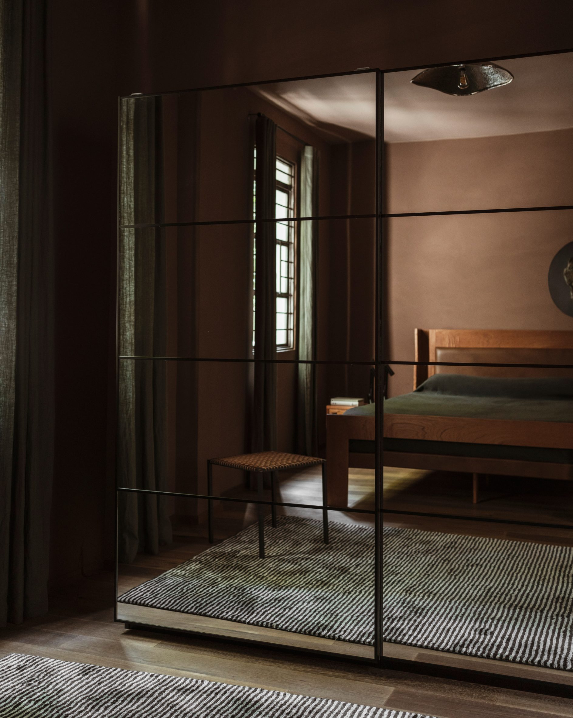 Bedroom reflected in mirrored wardrobe