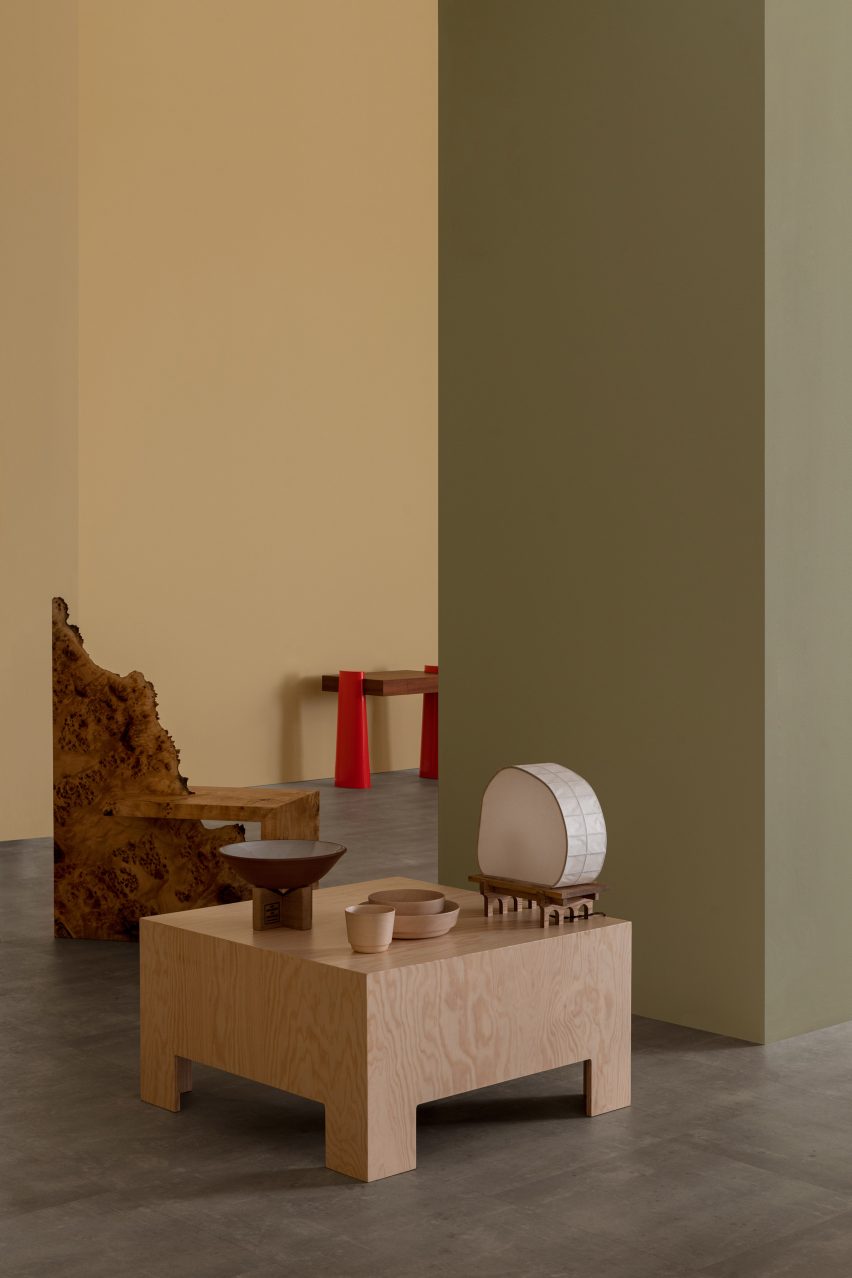 Wooden furniture in front of pale green wall