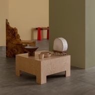 A small wooden table holding wooden sculptures