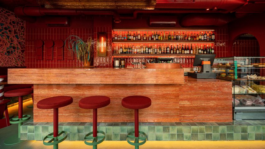 Red travertine bar in Va Bene Cicchetti interior by Noke Architects