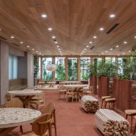 Nori Architects uses natural materials and cedar log columns to retrofit Japanese office