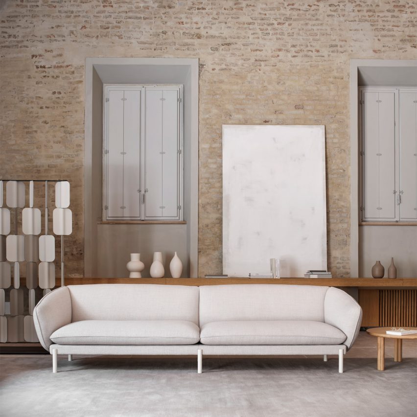 White Not Sofa by True Design in a living space with a brick wall