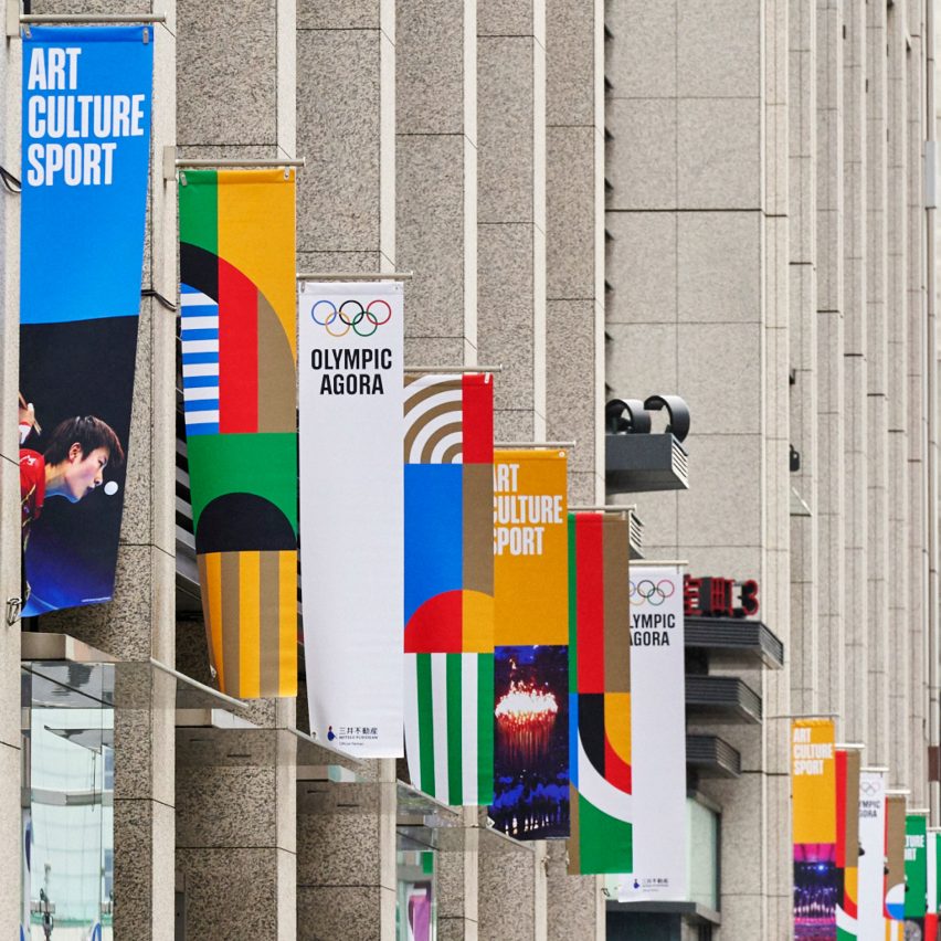 Banners with the Olympic brand identity on the side of a building