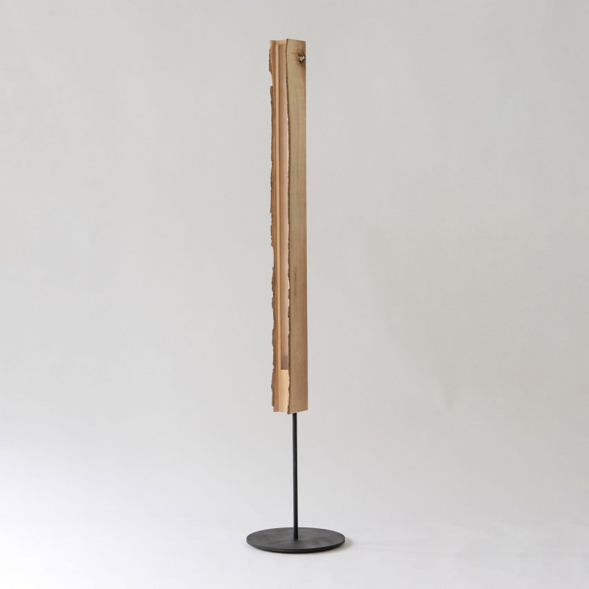 Photograph showing standing lamp with raw edge wood