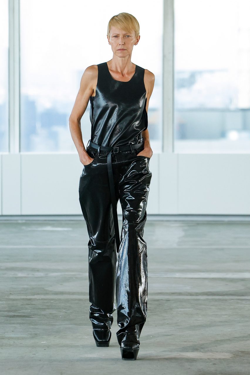 A model is pictured wearing a black glossy look that uses TômTex's biomaterial