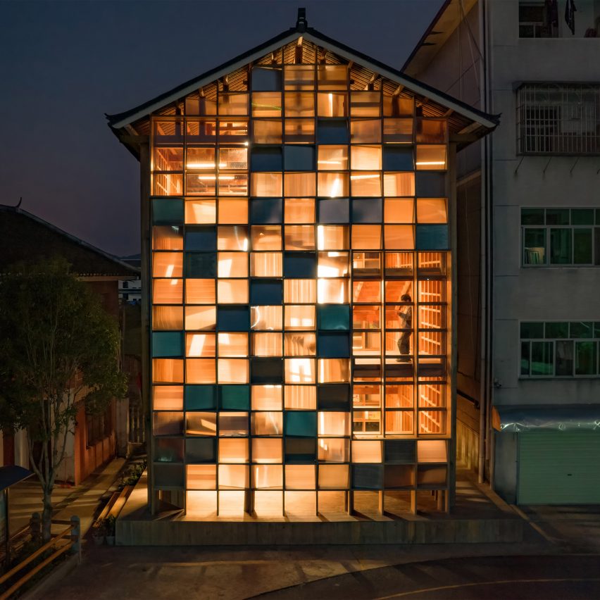 Pingtan Book House exterior with transparent and solid windows lit up at night