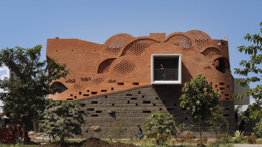 PMA madhushala wraps Indian home in perforated wall of brick and stone