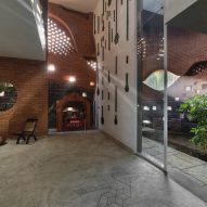 PMA madhushala wraps Indian home in perforated wall of brick and stone