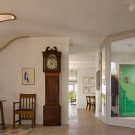Hallway with grandfather clock in Red House by David Kohn Architects