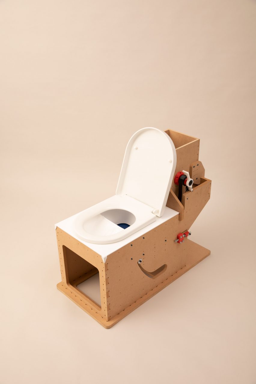 Prototype of toilet built from MDF with plastic seat and levers