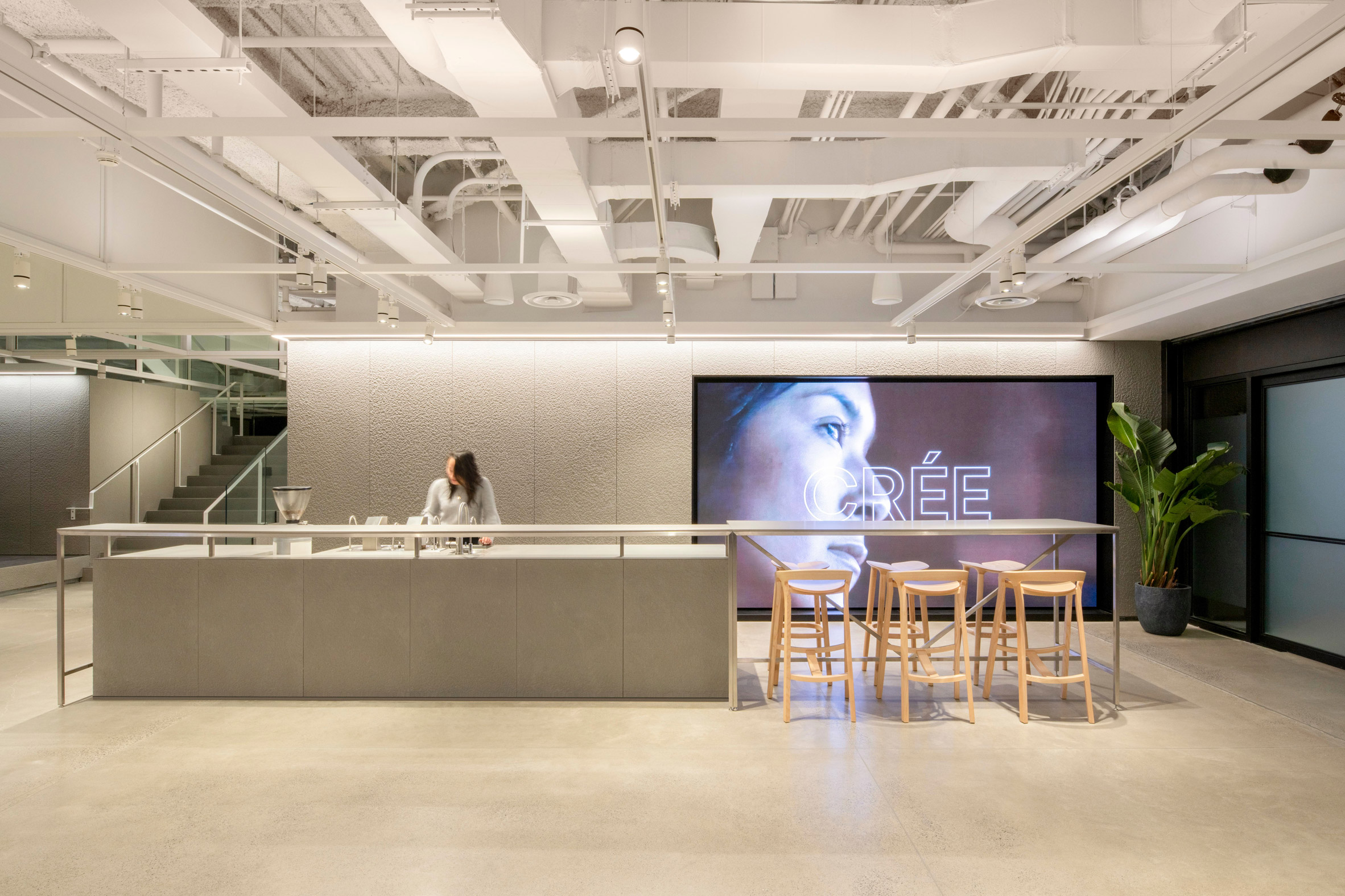 Ground floor of Sid Lee offices with coffee bar and digital screen
