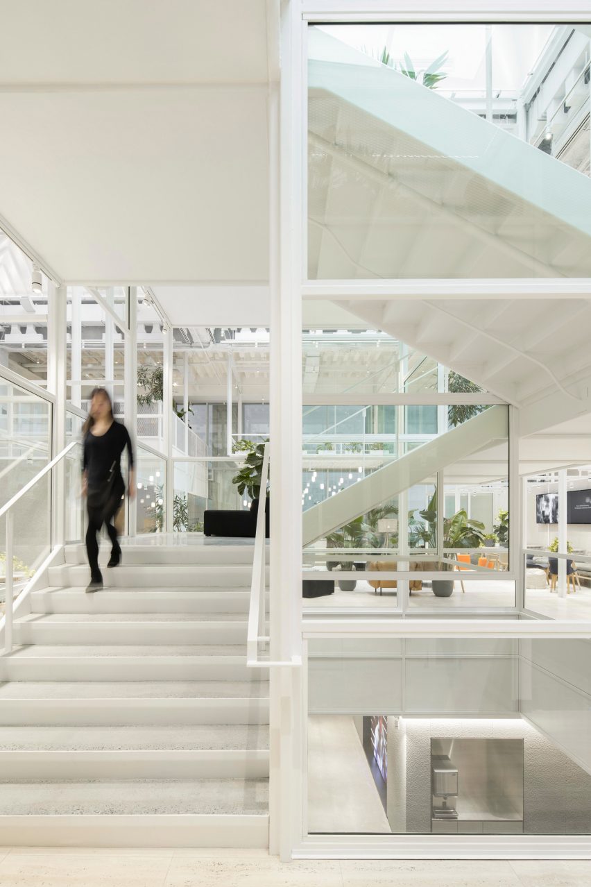 White staircase with glass and atrium in the background