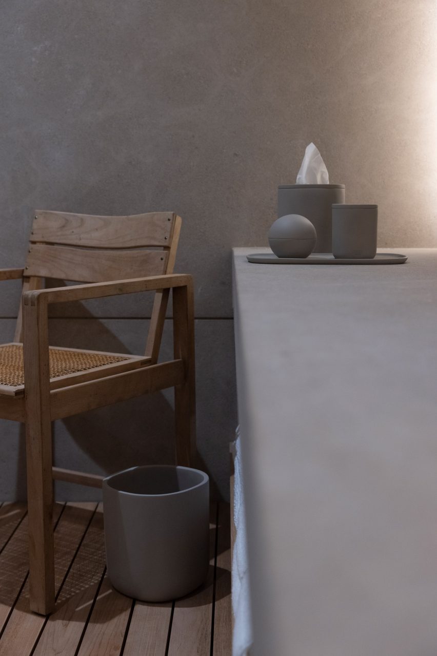 A wooden chair and concrete bathroom products