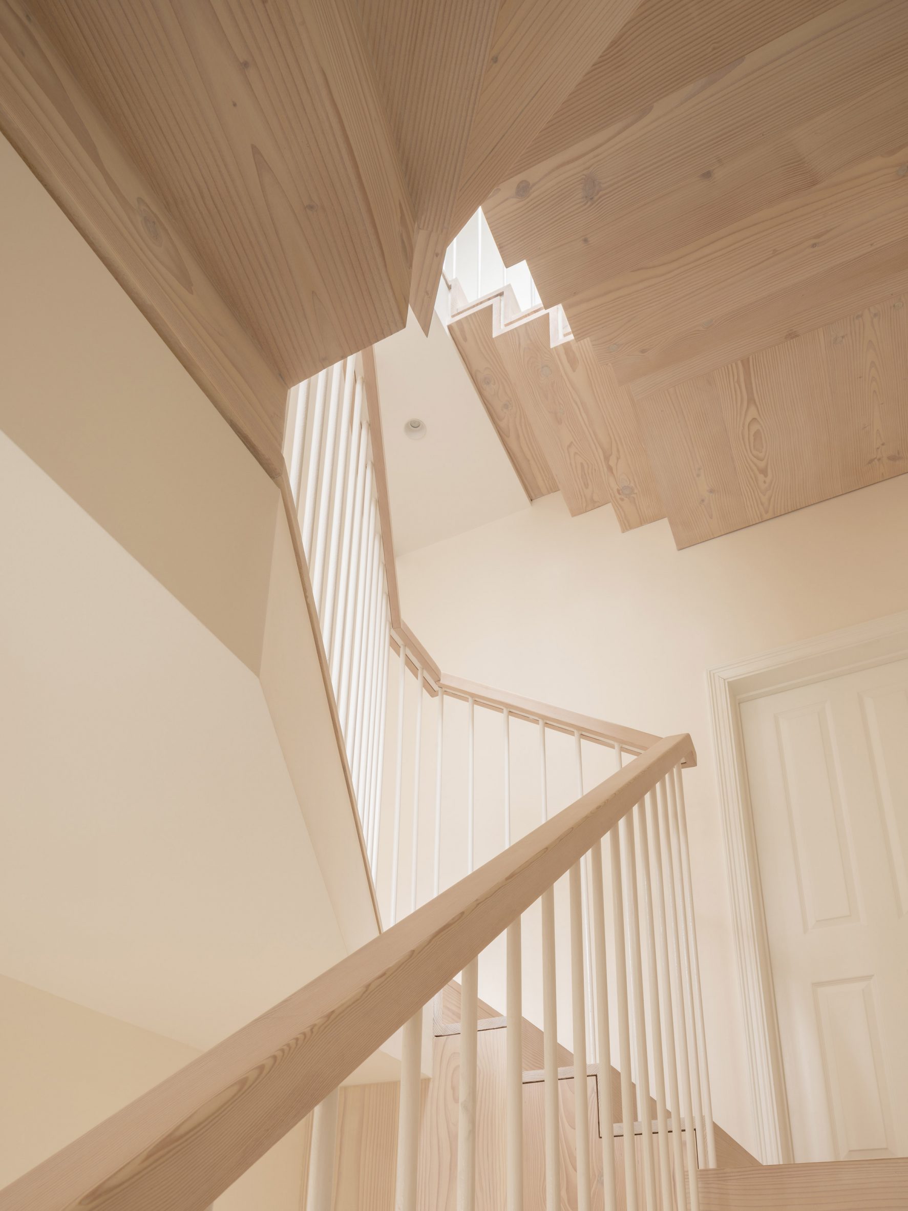 Folded-steel stair with wooden cladding