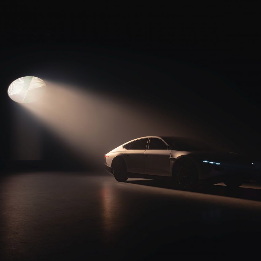 Lightyear 0 solar-powered car silhouetted against a black backdrop