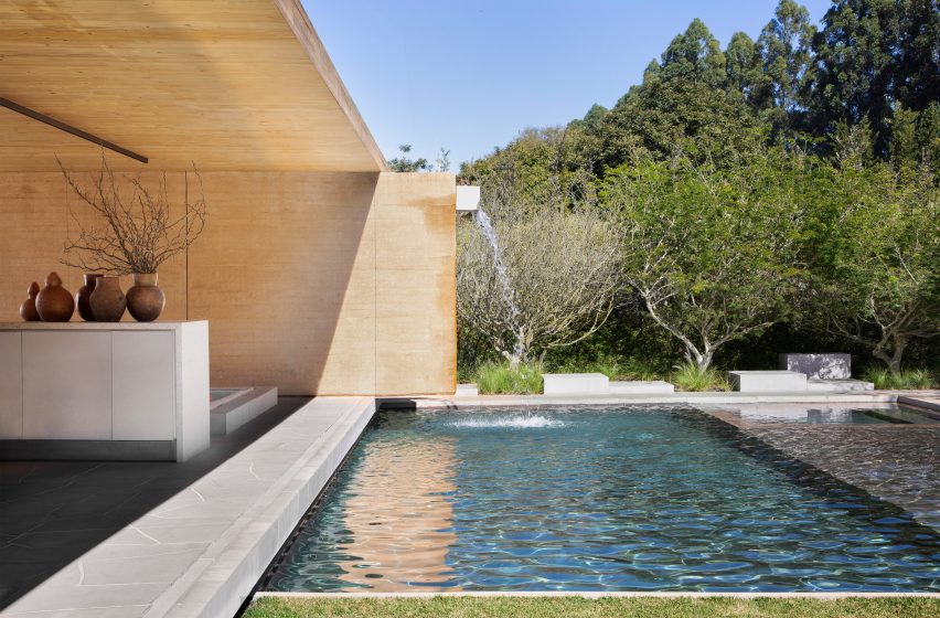 Timber and rammed earth villa in Brazil with pool and trees by Studio Guilherme Torres