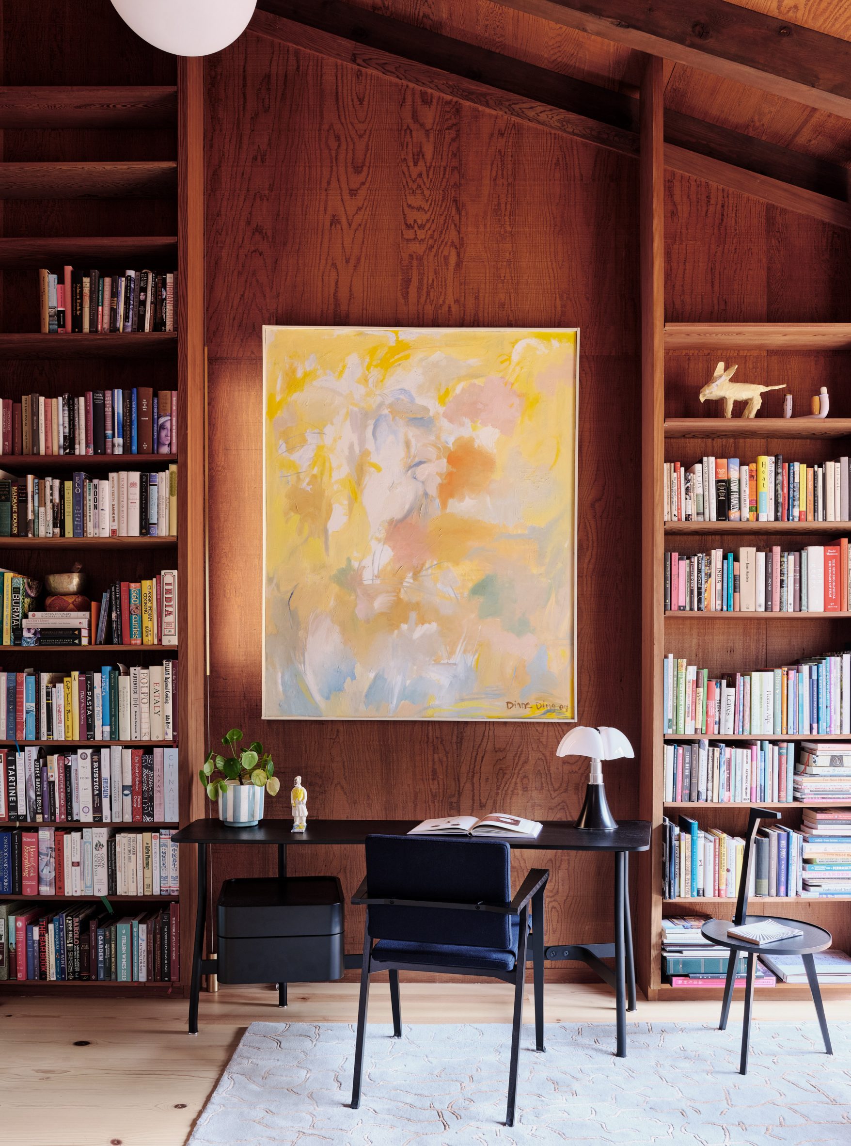 Cedar shelf library with abstract painting 