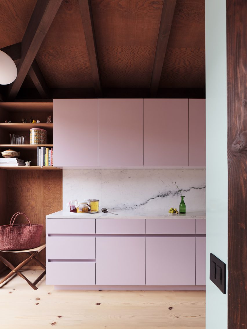Pink cabinets with marble backsplash