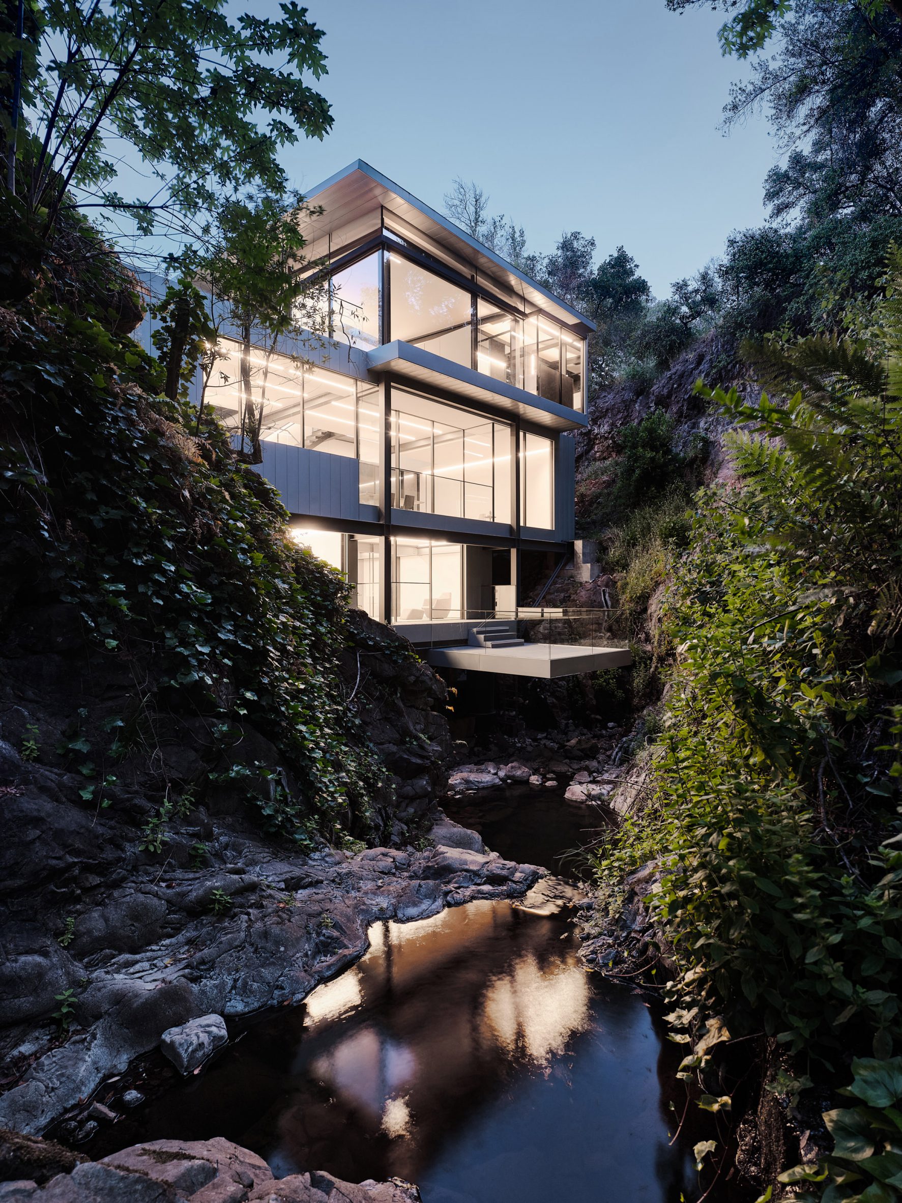 Suspension House in creek with steps down to water by Fougeron Architecture