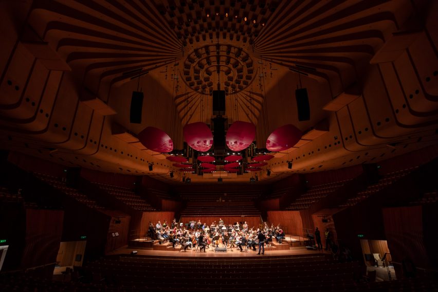 Orchestra rehearsing in an empty concert hall
