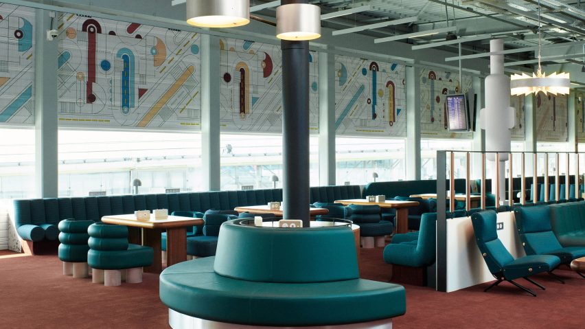 Photograph showing airport departure lounge with abstract mural above windows and green seating