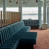 Photograph showing airport departure lounge with green bench seats