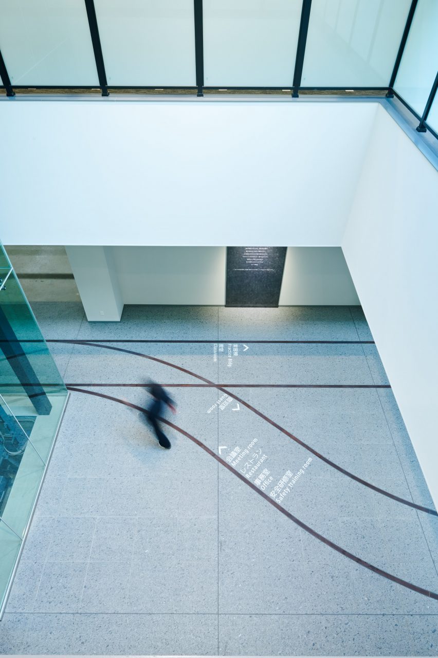 Lobby in the Totetsu Training Institute showing railway-inspired wayfinding markings on the floor