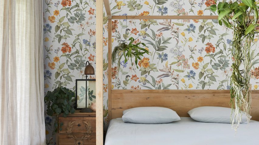 White Deco floral wall tiiles by Marazzi on the back wall of a bedroom with a four poster bed