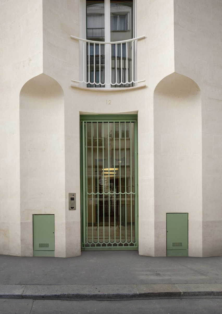 Front door of the 12 Rue Jean-Bart social housing with pale green door grill