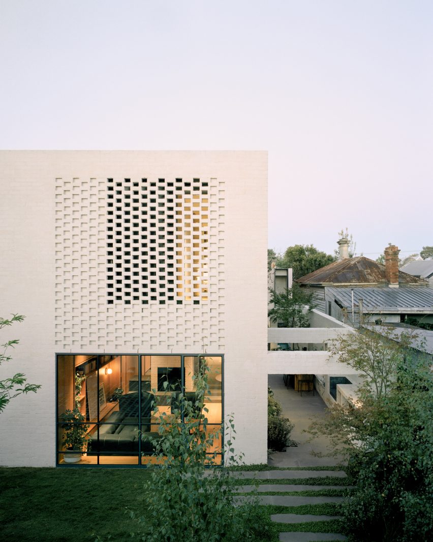 White-brick house with perforations in the facade