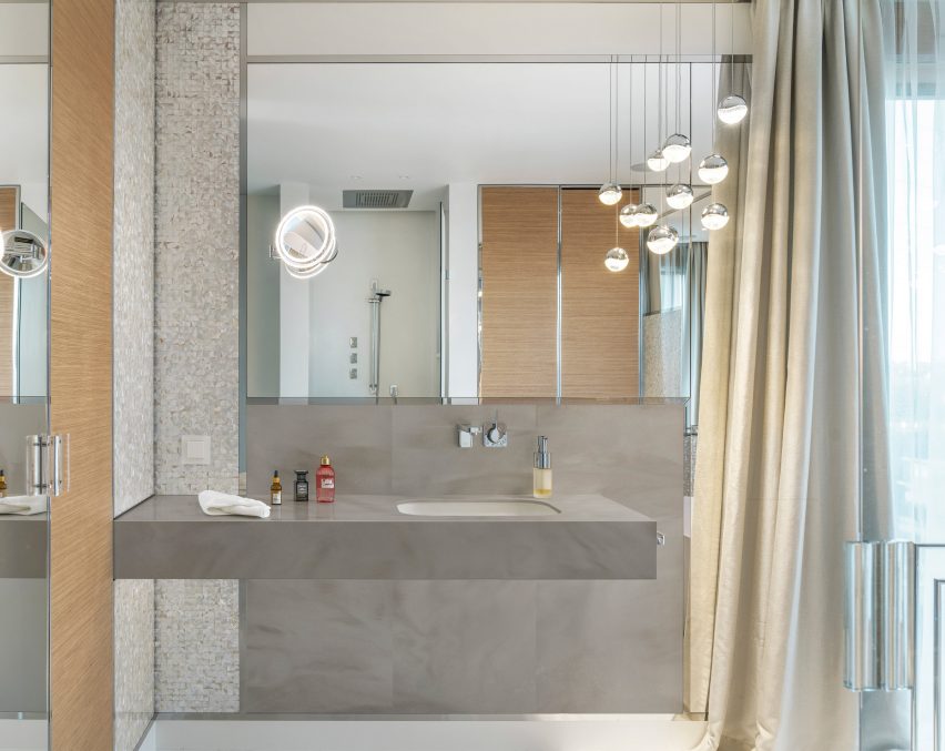 A bathroom with a grey countertop featuring Corian Solid Surface