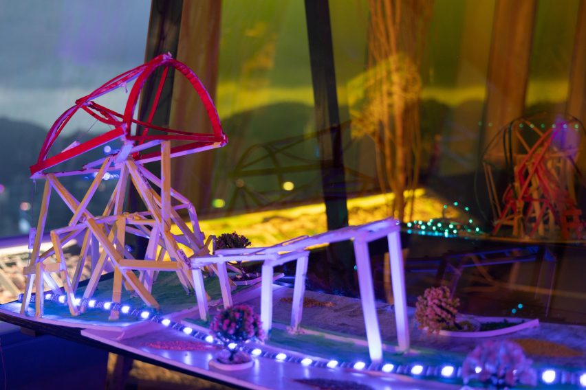 An architectural model of a student project lit up by LED lights