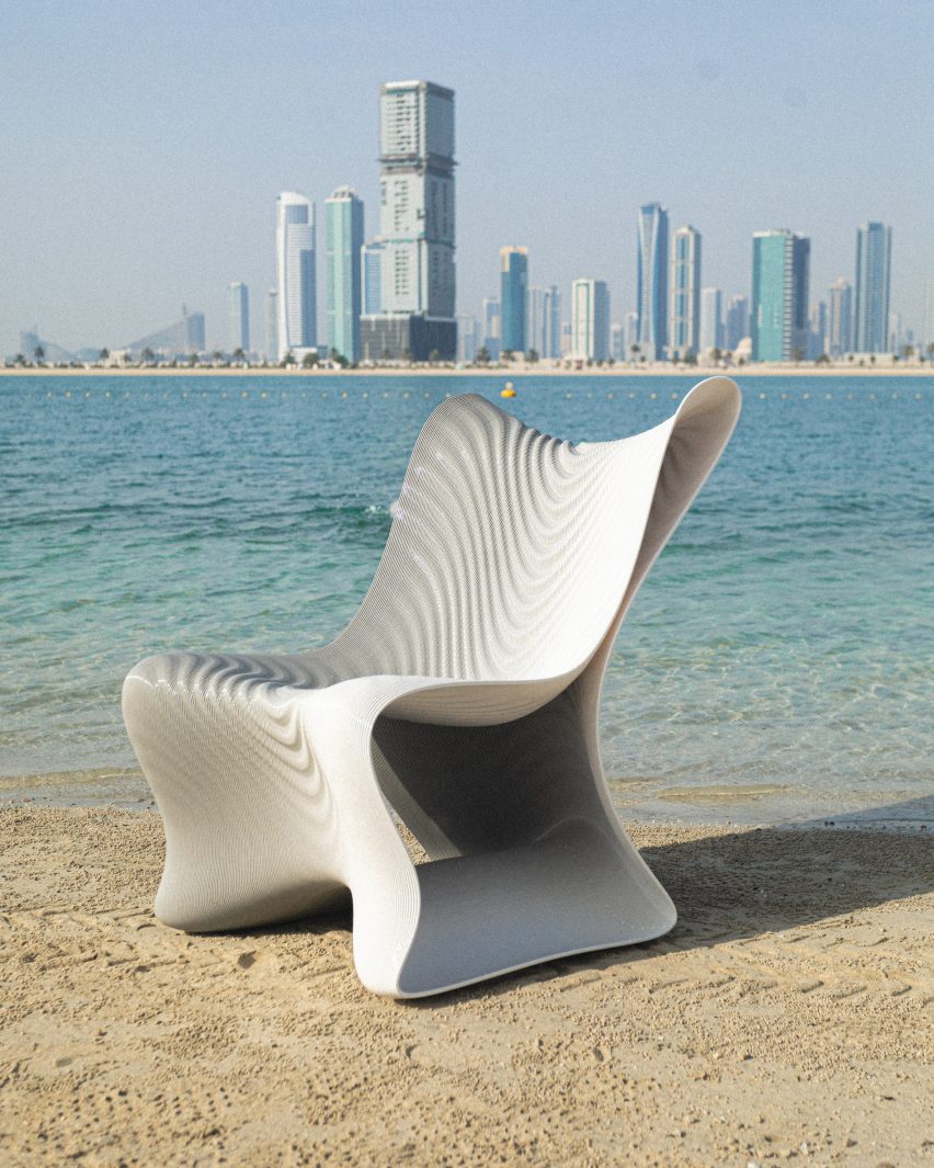 Photo of a 3D-printed chair on a beach