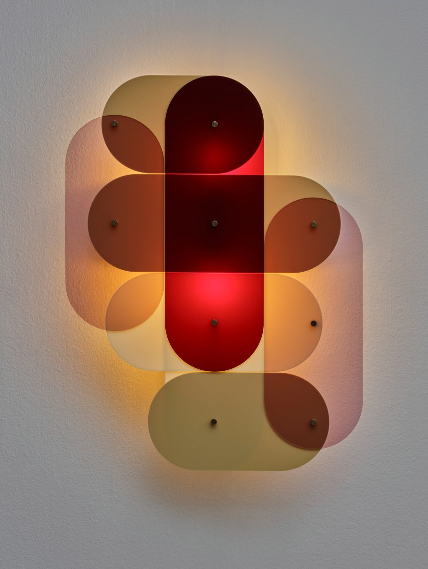 Photograph of a wall-mounted light made of different colours