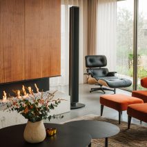 Eames lounge chair next to open fire