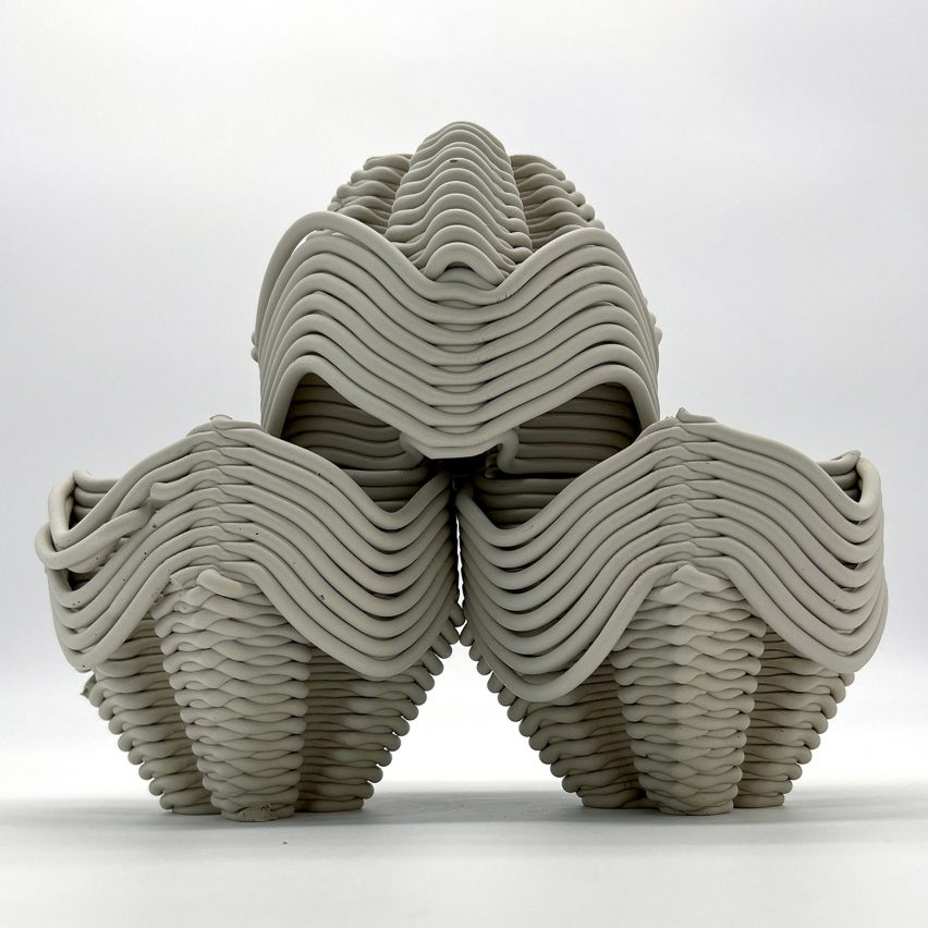 Three clay sculptures stacked on top of eachother