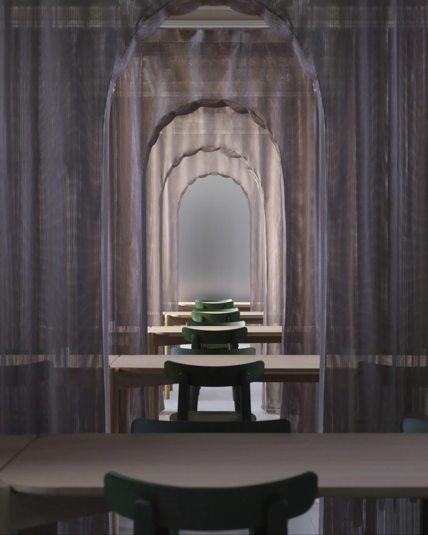 Image of desk spaces set in front of mesh arches at PROUD Gallery Gotanda