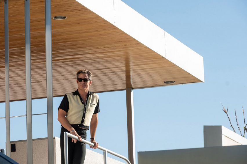 A character standing in a modernist house