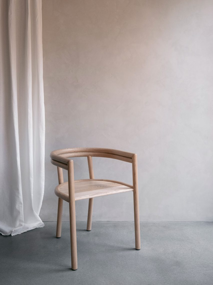 Elsie wooden chair with armrests in a neutral-toned room