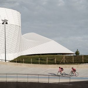Cyclists in front of aluminium sports centre