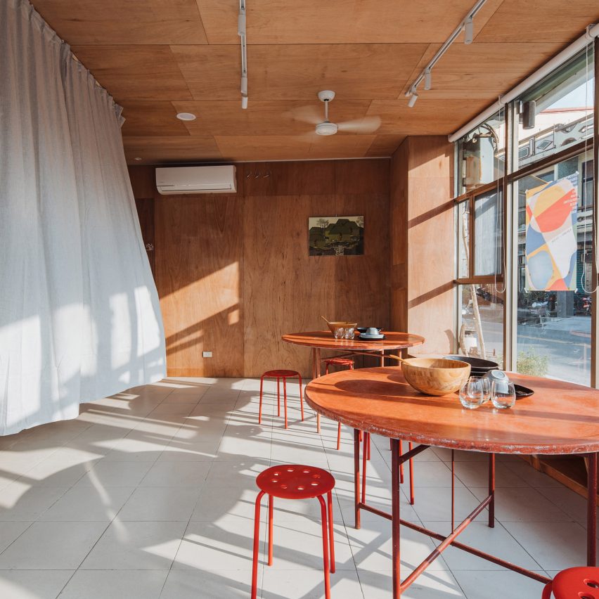 Red tables and chairs in F.Forest Office community centre in Taiwan by Atelier Boter