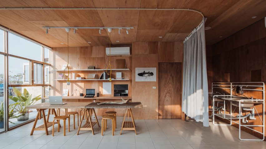 Interior of F.Forest Office community centre in Taiwan by Atelier Boter with desk surrounded by chairs